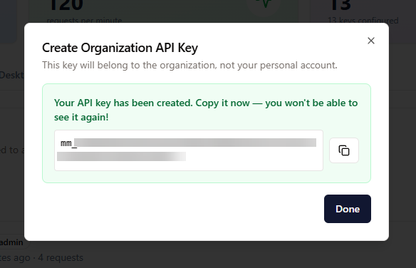 The “Create Organization API Key” dialog with a copy button and a warning to copy the key now.